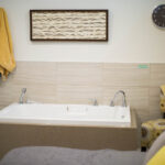 Picture of the birth center, bath tub surrounded by chairs.
